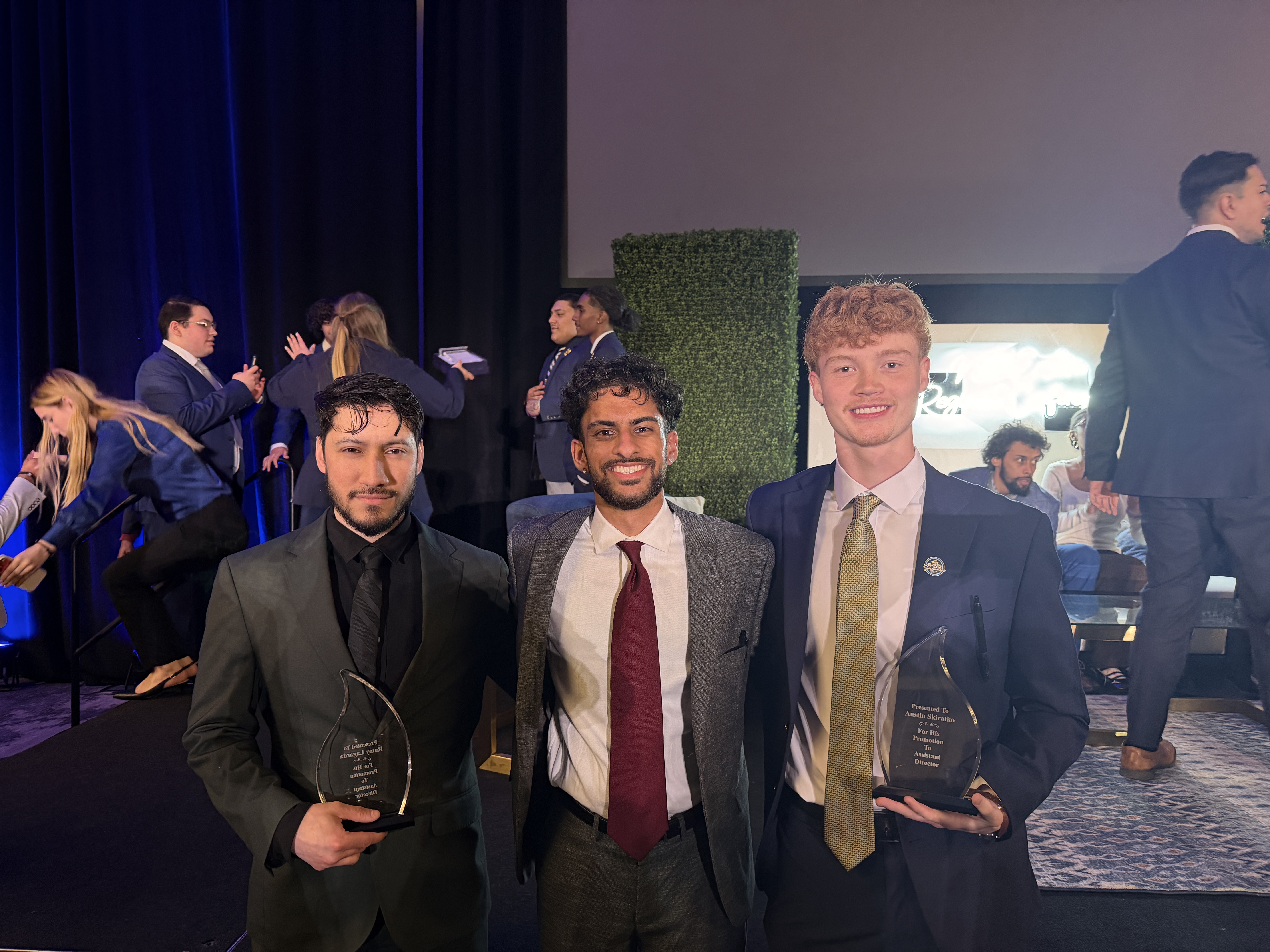 NorthCrest Capital team members at an award ceremony holding recognition trophies